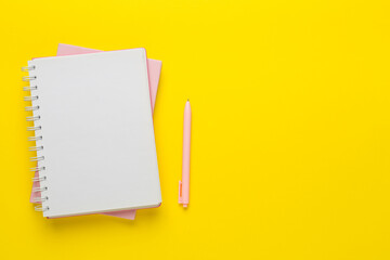 Notebooks with stationery on color background, top view