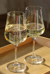 Two glasses of sparkling wine glittering in the light