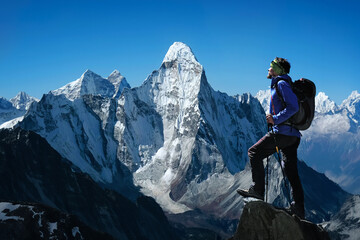 Man on peak of mountain. Mountain peak Ama Dablam. National Park, Nepal.