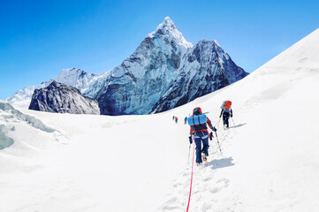 Group of climbers reaching the Everest summit in Nepal. Team work concept. Everest region - 631306638