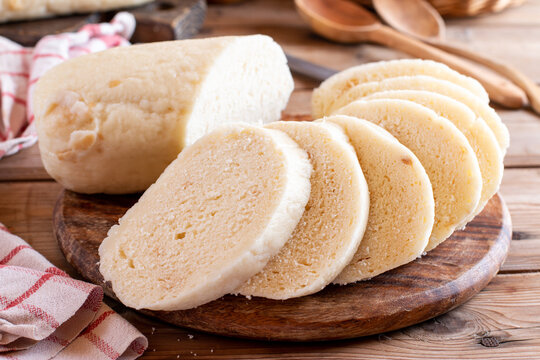 Preparing dumplings (knedliky) (steamed and sliced bread-like) on a board are typical of Czech cuisine.