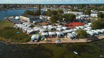 camping with trailers and campers at sea shore with beach, campsite aerial view