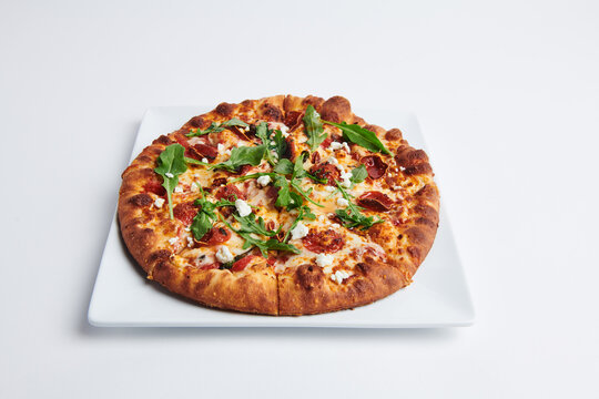 Pepperoni pizza with gourmet cheese and arugula 