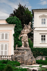 statue in the garden of the palace in summer time