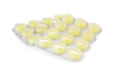 Blisters with yellow cough drops isolated on white. Cold remedies