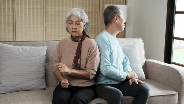 Senior Asain couple, fight and divorce in stress, conflict or argument from disagreement on living room sofa at home.