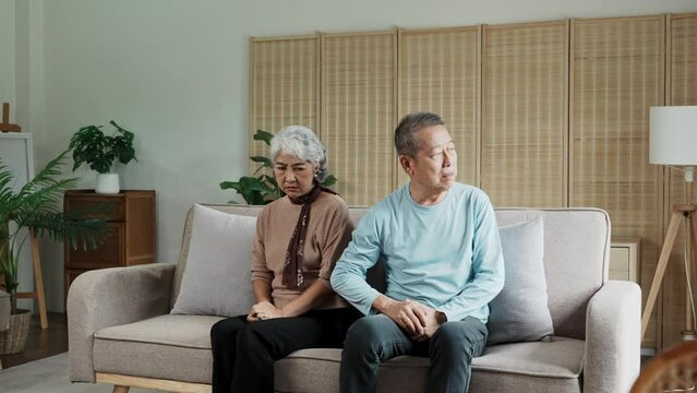 Senior Asain couple, fight and divorce in stress, conflict or argument from disagreement on living room sofa at home.