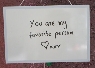 Whiteboard with a romantic love message written in black marker