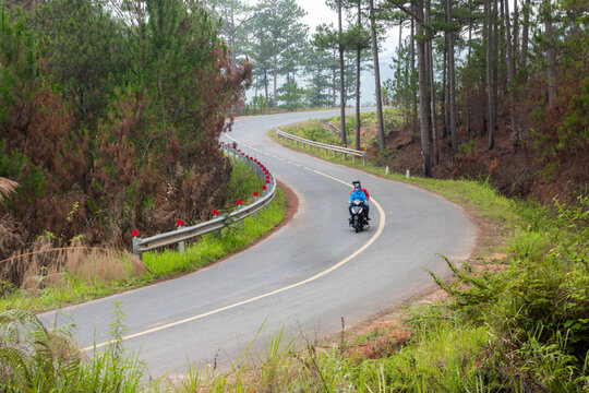 A pass road with people and motorbikes moving at lac duong, dalat, lamdong, vietnam
