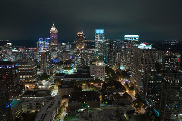 Fototapeta na wymiar View from above of brightly illuminated high skyscraper buildings in downtown district of Atlanta city in Georgia, USA. American megapolis with business financial district at night