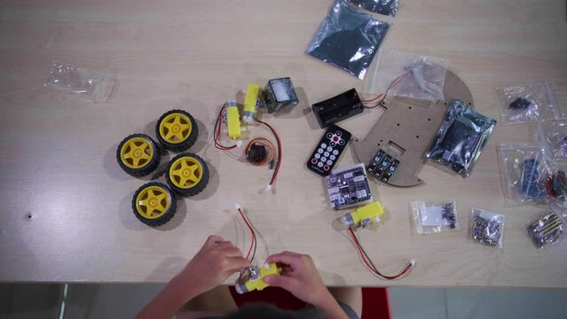 Asian  Student Boy Building Robot Vehicle In After School Computer Coding Class technology of robotics programing and STEM education concept.