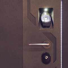 Image of a steel door with a fingerprint scanner.