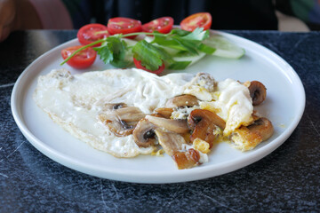 Egg Omelette with mushroom on a white plate for breakfast 