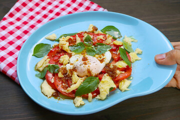 Mouthwatering Homemade Caprese Salad with a Poached Egg for a Healthy Breakfast