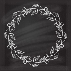 Floral decoratare frame on a chalkboard background. Ivy leaves vintage style wreath