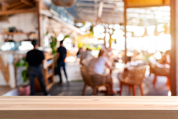 Empty wooden table space platform and blurry defocused restaurant and coffee shop