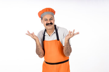 indian cook giving happy expression on white background.