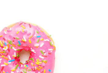 A  closeup picture of doughnut with strawberry coating and sprinklers on copyspace white background.