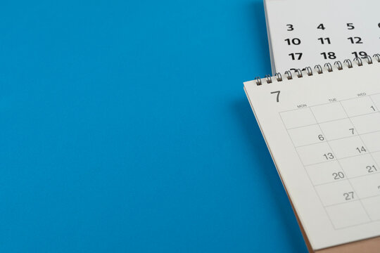 close up of calendar on the blue table background, planning for business meeting or travel planning concept