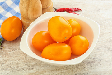 Sweet ripe yellow tomato in the bowl