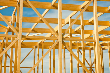 construction of a building made of wood in the background blue sky