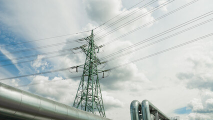 pipelines and power lines against the background of blue sky and clouds - obrazy, fototapety, plakaty