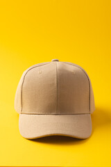 Cream baseball cap and copy space on yellow background
