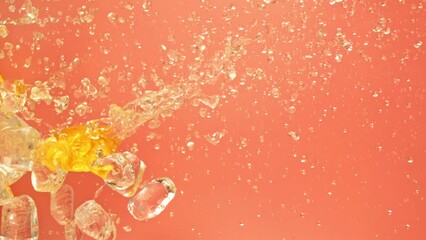 Juicy tasty sweet bright vibrant orange fly along on ice and water splashes drops in super slow motion. Cool rich juicy citrus cold oranges slices falling or exploding on pink background on 1000 fps