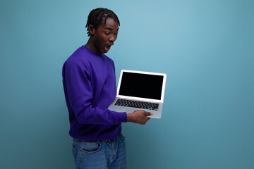 office specialist african young brunette man with dreadlocks with laptop