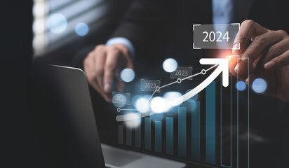 Businessman pointing increase arrow graph corporate future business goals on year 2024, planning...