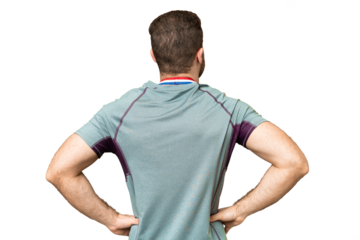 Young handsome blonde man with medals over isolated chroma key background in back position