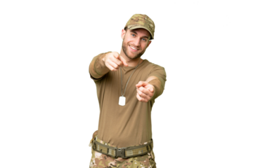 Military with dog tag over isolated chroma key background points finger at you while smiling
