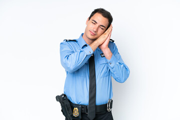 Fototapeta premium Young police caucasian man isolated on white background making sleep gesture in dorable expression