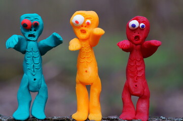 Obraz premium Figures of three funny different zombies. Colorful toys.