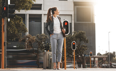 City, walking and woman on a crosswalk wait with travel, business commute and urban journey. Road,...