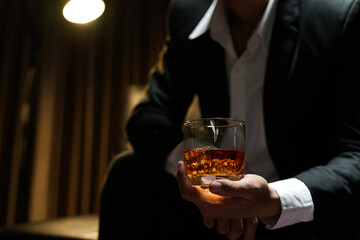 businessmen holding a glass of whiskey
