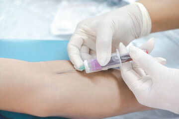 Close up hand of nurse, taking blood sample from a patient in the hospital