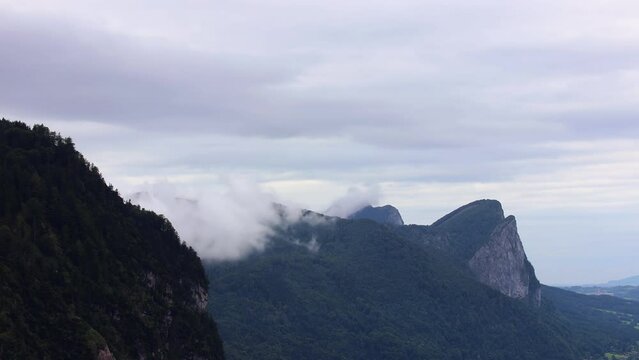 Time lapse fog created around drachenstein Alp mountain. Overcast weather in hill valley, Austria