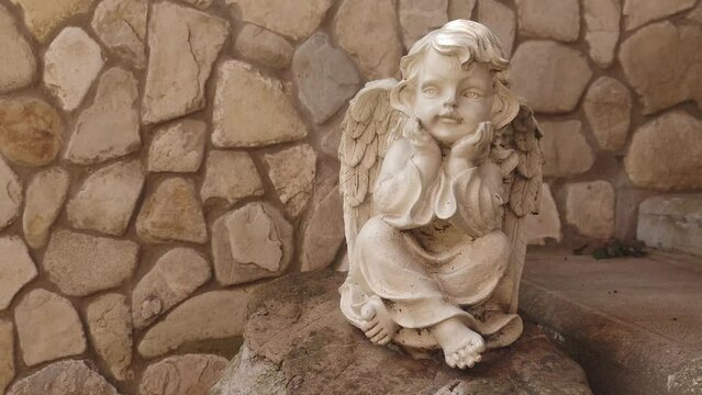 Russia Tuapse 07.07.2023 Stone statuette of an angel in the park in summer.