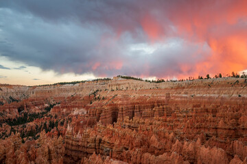 reddish illuminated clouds over bryce canyon