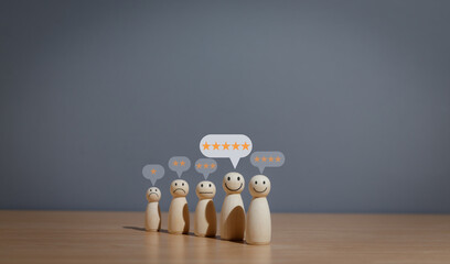 Wooden puppet on table, smiley face and star icon Comment on satisfaction rating or good experience...