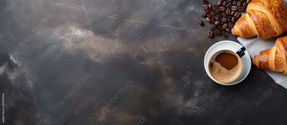 Poster Fresh croissants and coffee placed on a stone table as seen from above, with empty space for adding