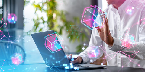 Man with laptop using blockchain interface in office, metaverse