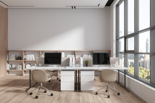 White and wooden open space office with bookshelves