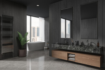 Dark wooden bathroom corner with tub and double sink