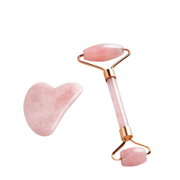 Pink jade facial roller and gua sha isolated, top view