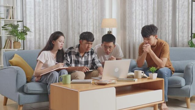 Asian Teen Group Studying At Home. Students With Books Looking At A Laptop, Feeling Sad And Disappointed, Failure With Project
