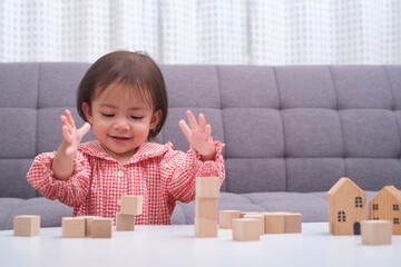 The little baby child playing toys. Kid learn and education from wooden block and rainbow color...