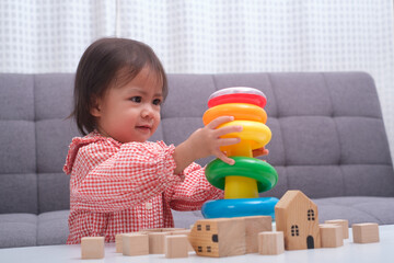 The little baby child playing toys. Kid learn and education from wooden block and rainbow color toy, avtivity at home or study in preschool nursery school. strengthen development concept.