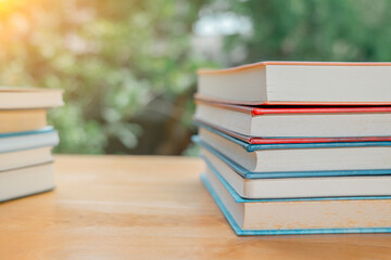 Stack or plie of vintage old books on wooden table. Learning, education and study concept. one of them open with copy space.